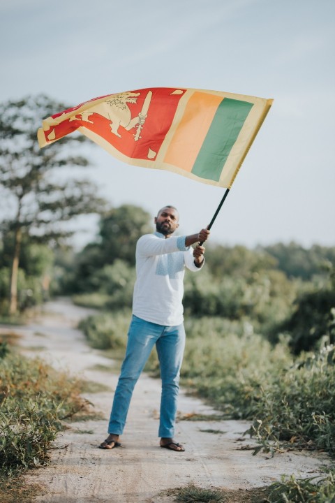 Man Waving Sri Lanka National Flag Sinha Kodiya Jathika Kodiya  (1)